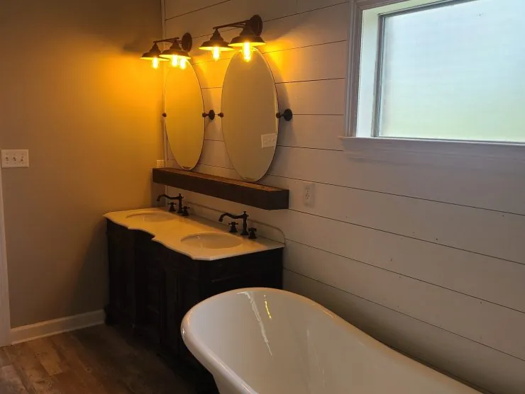 Bathroom remodel with freestanding soaking tub, shiplap wall and reclaimed wood double vanity