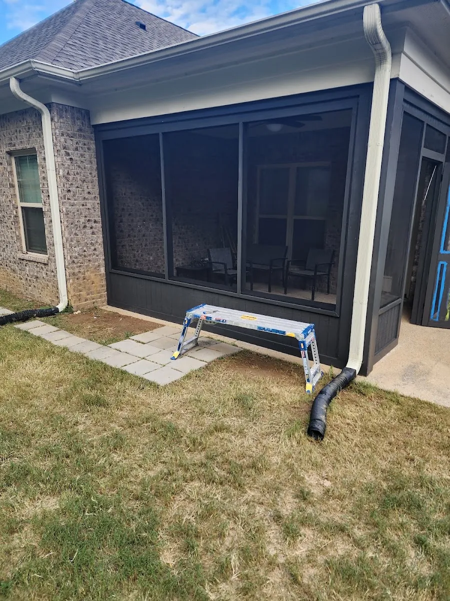 Screened-in porch addition with new columns and a poured concrete patio
