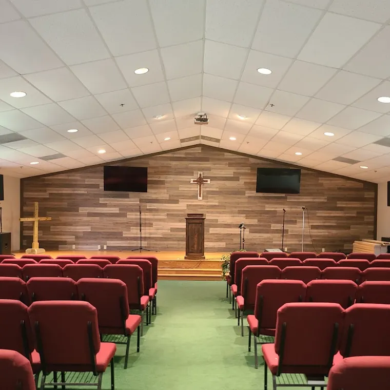 Commercial sanctuary remodel with a stained wood accent wall and new flooring