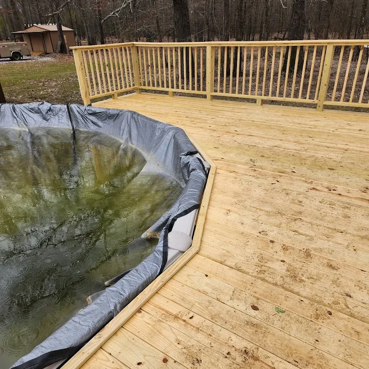 New deck framing and decking installed over a sloped back yard