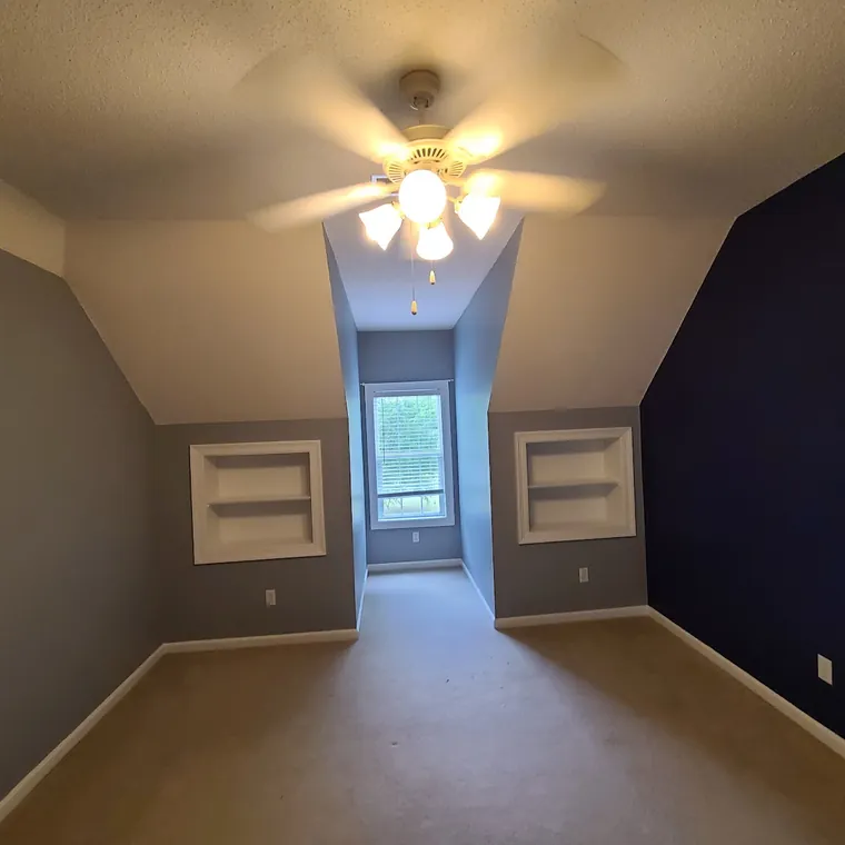 Bedroom with a painted accent wall and refinished ceiling